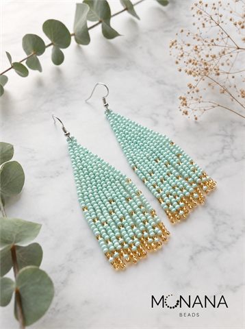 Mint green and gold beaded fringe earrings on marble